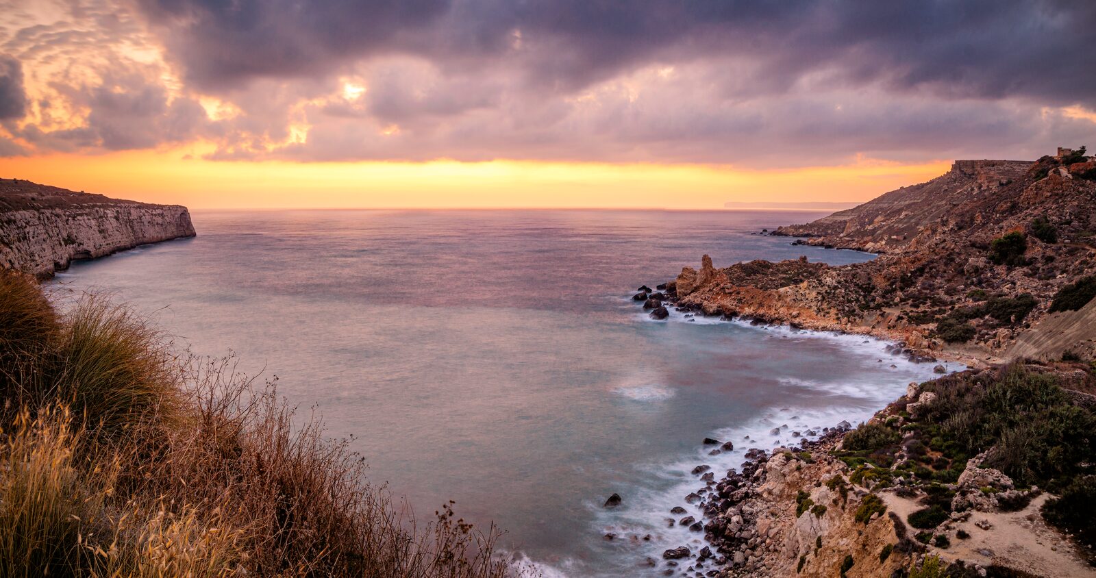 Warm sunset light over the bay and clay slopes of Fomm ir-Riħ, Malta