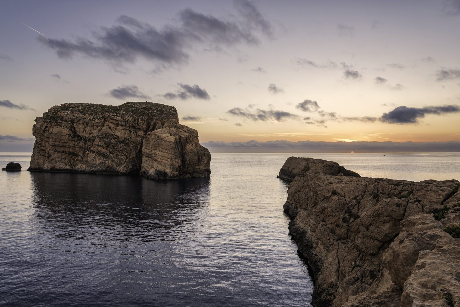 Fungus Rock standing in a calm sea at sunrise, Dwejra, Gozo