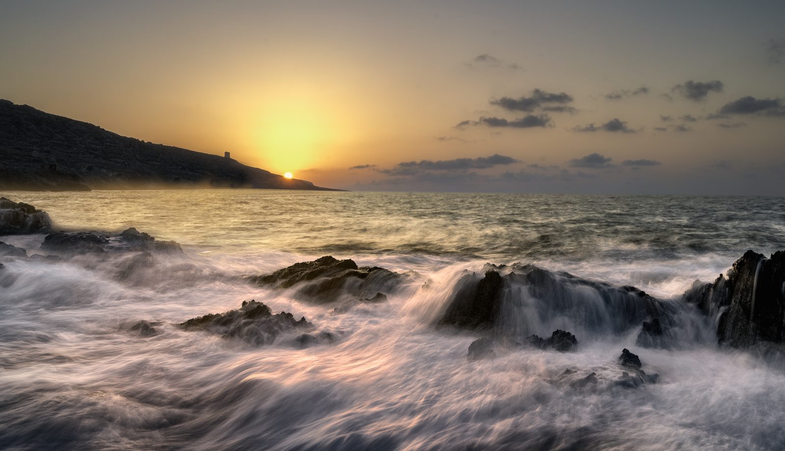 A wave in golden light off Għar Lapsi, Malta