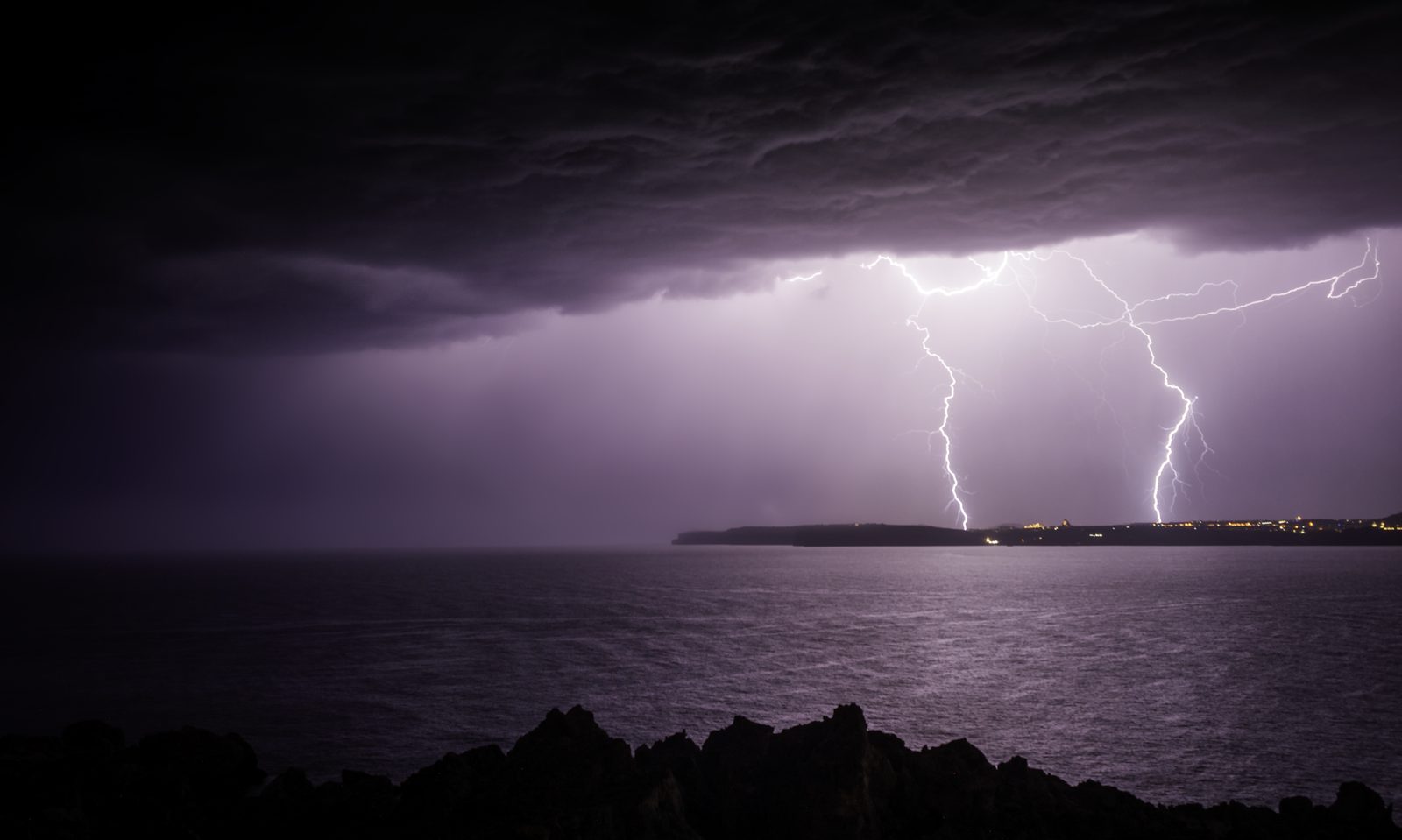 Twin lightning bolts over the sea off Mellieħa at night
