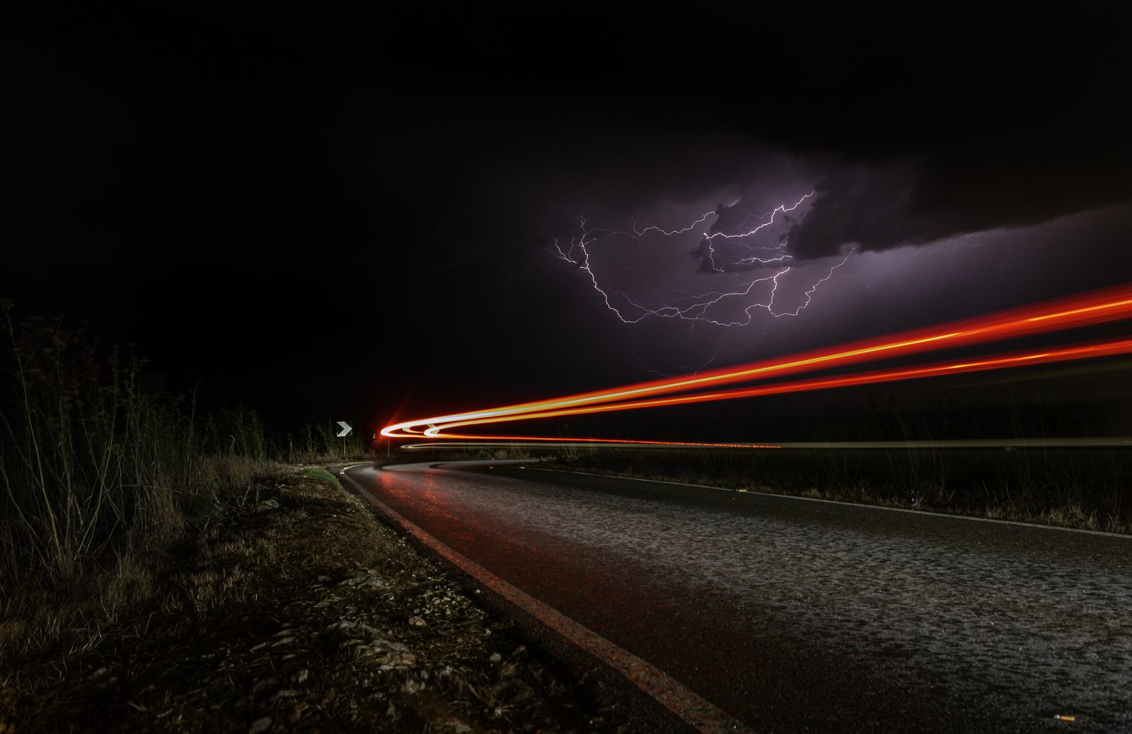 Lightning over an unfinished elevated road at night near Mellieħa