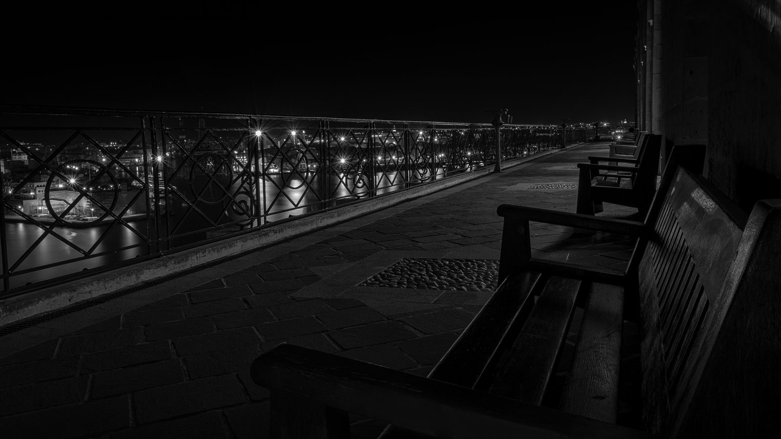 A bench at the Upper Barrakka Gardens, Valletta, in black and white